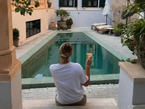 Solo travel in Mallorca with a traveller enjoying a peaceful moment by a pool in Palma