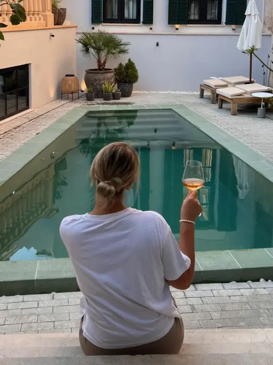 Solo travel in Mallorca with a traveller enjoying a peaceful moment by a pool in Palma