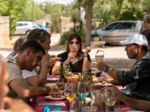 Balearic food producers with artisan cheese, bread and wine on a rustic farm table in Mallorca
