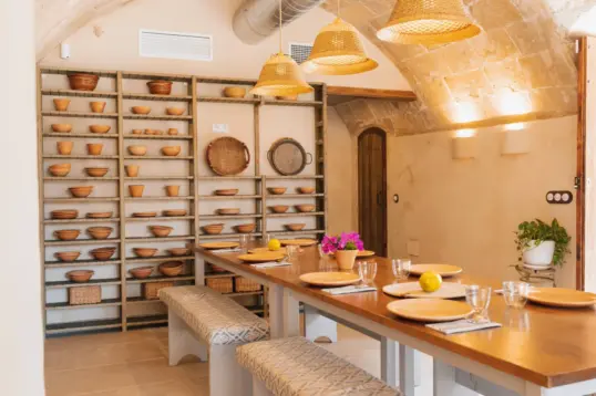 Cooking class in Palma de Mallorca at Moltak windmill kitchen with communal table set for a hands-on Balearic food experience